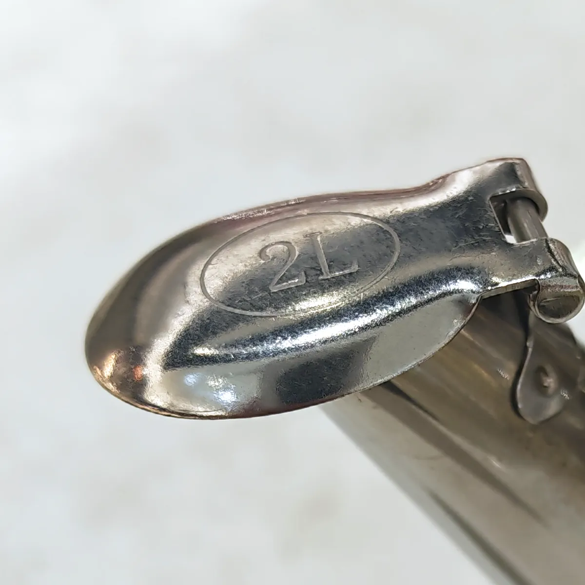 Hinged whistle cap on the spout, stamped with a 2L capacity mark