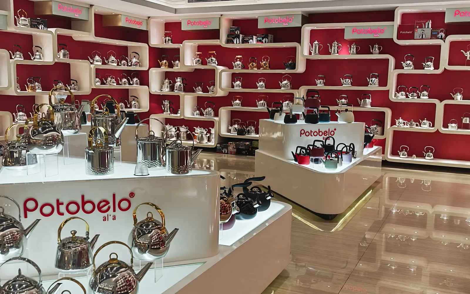 The Potobelo showroom floor: branded shelving and display islands carrying the stainless steel kettle range